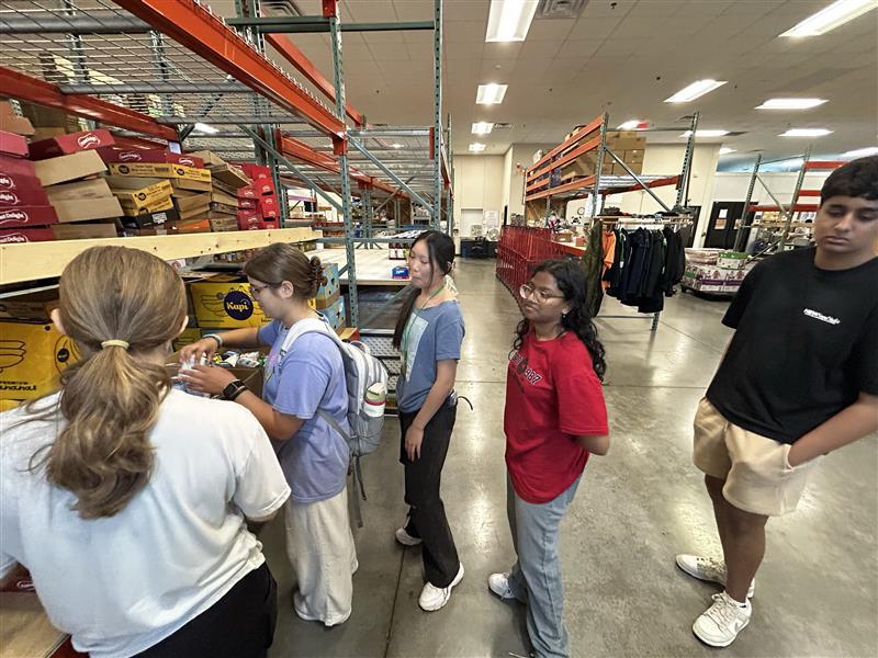 Students performing community service in warehouse
