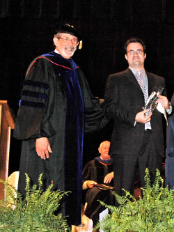 Kyle Holmes holding his award with Dr. Sinclair