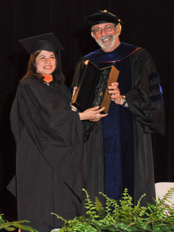 Dr. Sinclair and Laurie Carillo holding an award