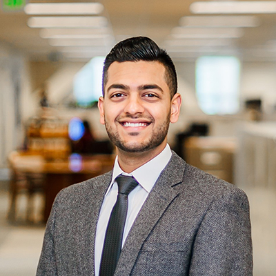 Riaz Jiwani standing in front of an office