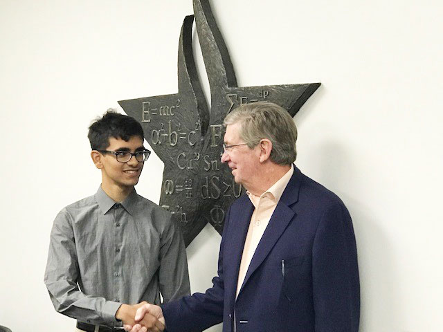 Ken Newman awarding scholarship to recipient Sumit Chakraborty